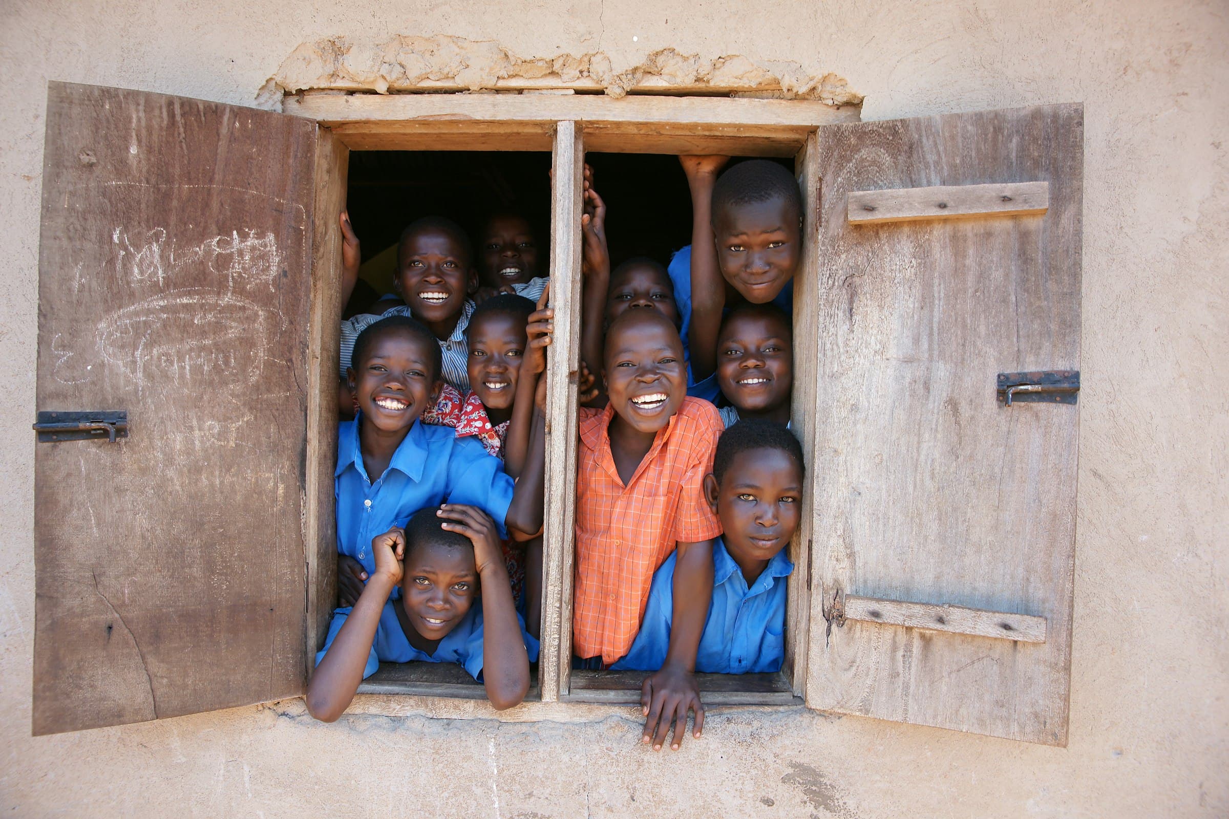 A group of young boys stand together at a school in Nakaseke, Uganda.